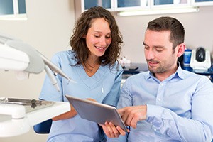 A young man consulting with his dentist about treatment