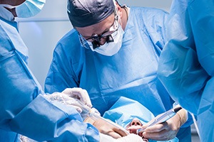 Dentists performing a dental implant surgery