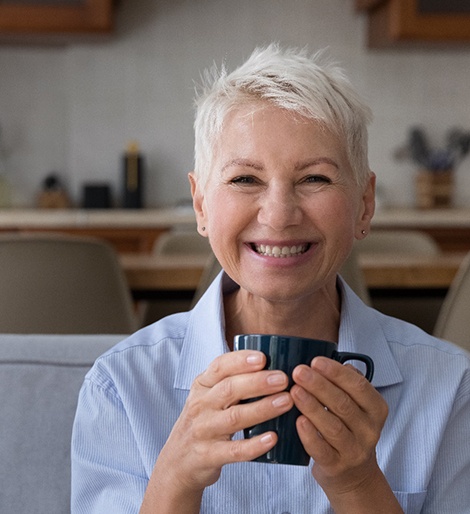 Woman smiling and holding a mug