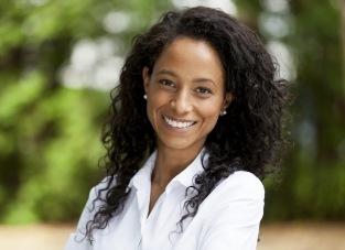 Smiling woman in white buttoned blouse