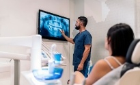 Dentist showing a patient an x ray of their teeth