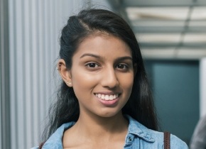 Young woman in denim shirt smiling