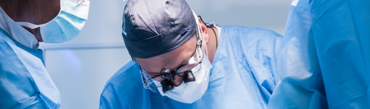 Dentist wearing dental binoculars while performing a treatment