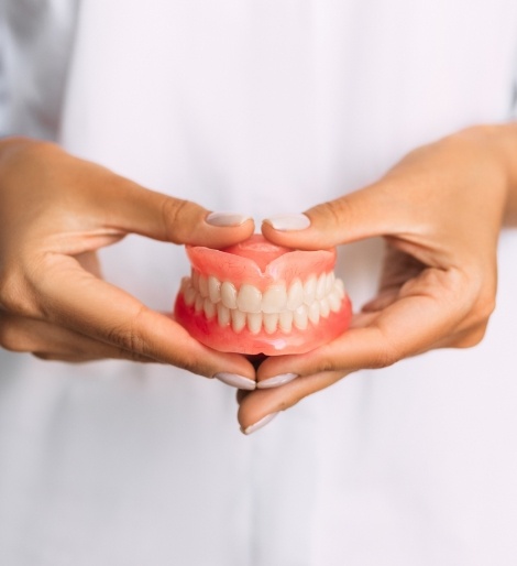 Dentist holding a set of full dentures