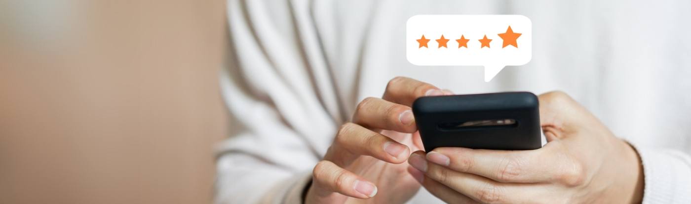 Person leaving a five star review on their phone